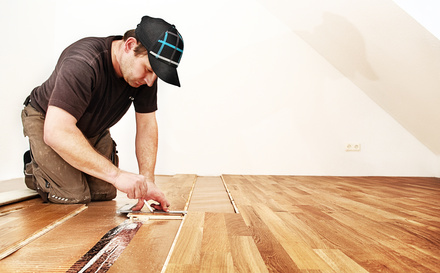 man installing flooring