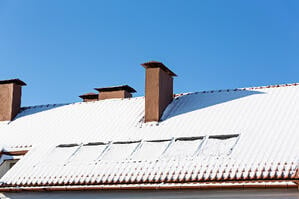 Snow collected on rooftops is a major source of snow melt moisture intrusion at the end of winter.