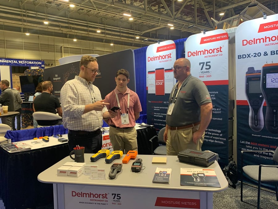 Delmhorst staff members at their booth during the RESTORE Conference & Expo 