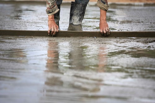 Concrete being leveled while wet