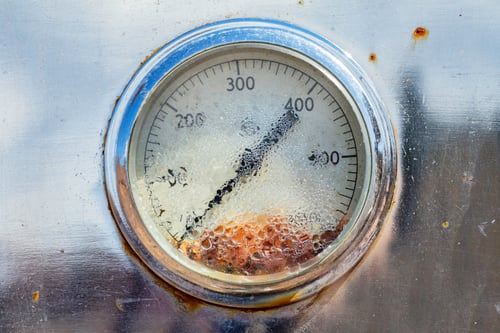 Vintage gauge covered with moisture droplets, rusting from the inside