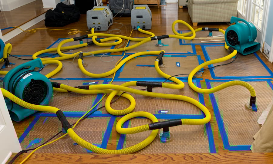 Water mitigation pumps and dryers to suck the water out of a flooded hardwood floor