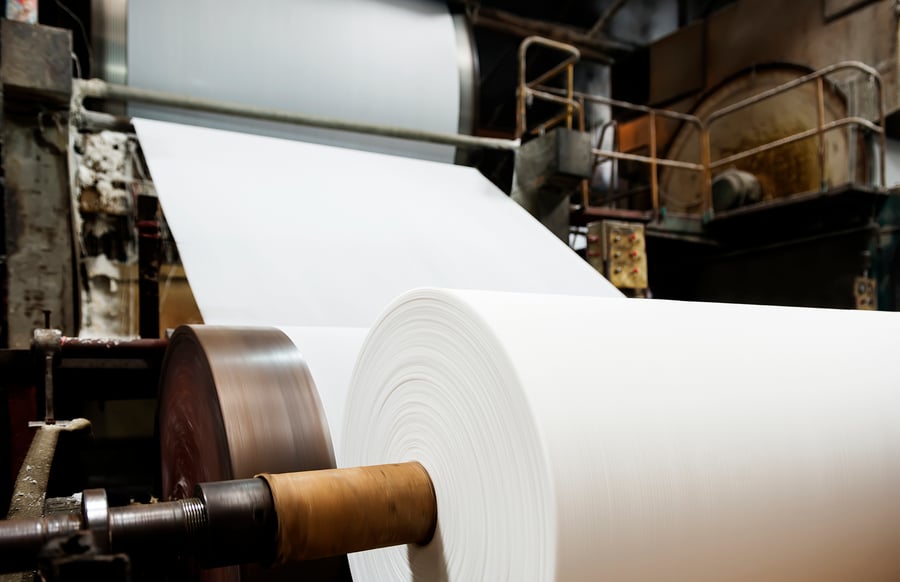 roll of paper on a manufacturing belt in a production plant