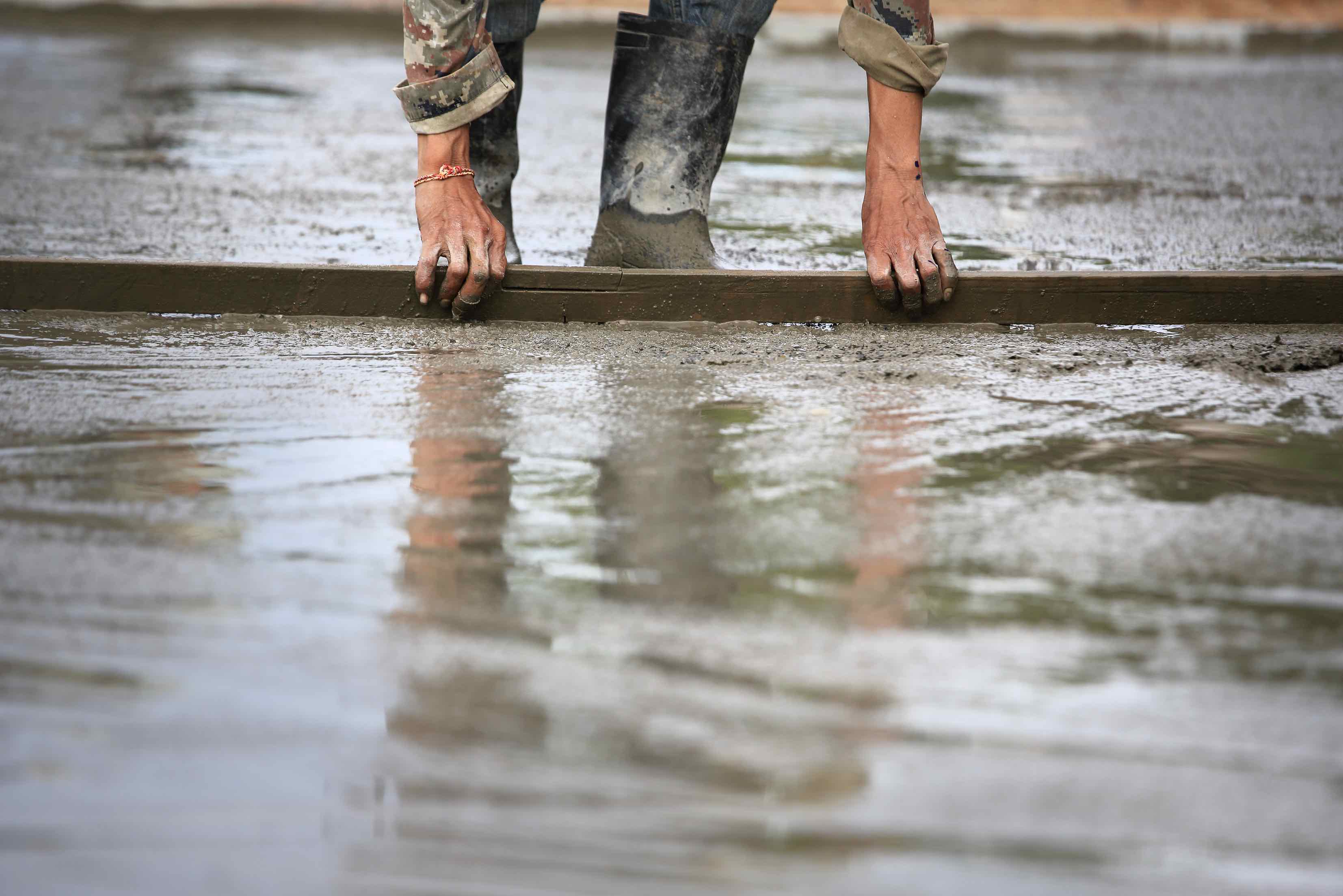 Concrete being leveled while wet